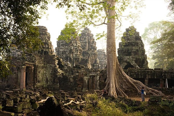 1-Day Angkor Wat Cycling Tour: Scenic Bike Adventure in Siem Reap - Angkor Thom and the Bayon’s stone faces