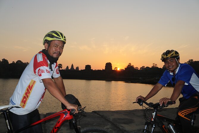 Angkor Sunrise Expedition Cycling Through Serene Backroads - Along Angkor Thom’s wall