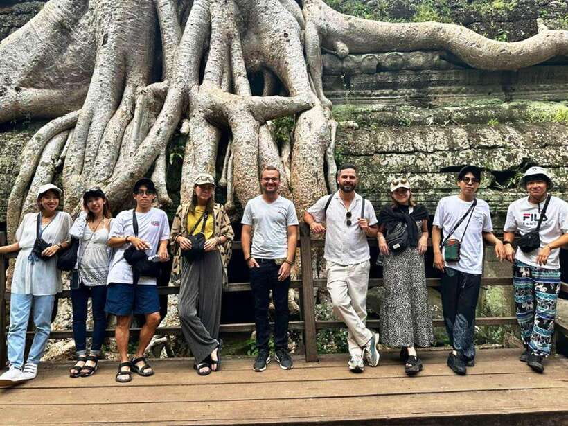 Explore Angkor Temple Sunset With Tour Guided - Walking beneath Angkor Thom’s four faces